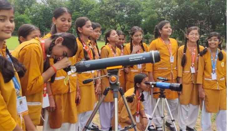 Students observing celestial bodies